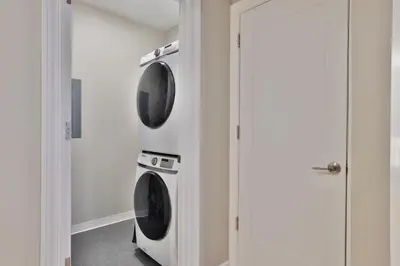 two washer and dryer units in a room at *New* XquisiteMidCenturyM0d~ Condo *OTR* w/Parking in Cincinnati