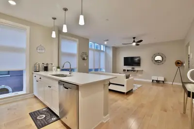 an open kitchen and living room with a couch at *New* XquisiteMidCenturyM0d~ Condo *OTR* w/Parking in Cincinnati