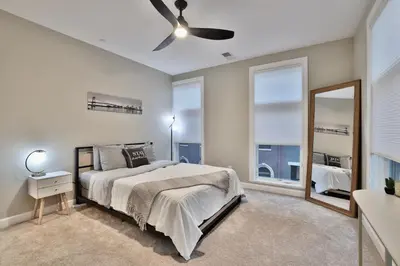 a bedroom with a bed and a ceiling fan at *New* XquisiteMidCenturyM0d~ Condo *OTR* w/Parking in Cincinnati