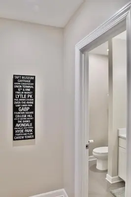 a white bathroom with a toilet and a mirror at *New* XquisiteMidCenturyM0d~ Condo *OTR* w/Parking in Cincinnati