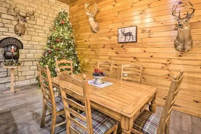 a dining room with a wooden table and a christmas tree at Walhonding Woods Secluded Farmland Retreat! in Walhonding