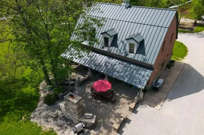 an overhead view of a building with a table and umbrella at Walhonding Woods Secluded Farmland Retreat! in Walhonding