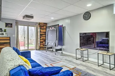 a living room with a blue couch and a large tv at Zen Studio about 20 Min to Downtown Columbus! in Blacklick