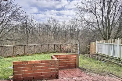 a brick wall in a yard next to a fence at Zen Studio about 20 Min to Downtown Columbus! in Blacklick