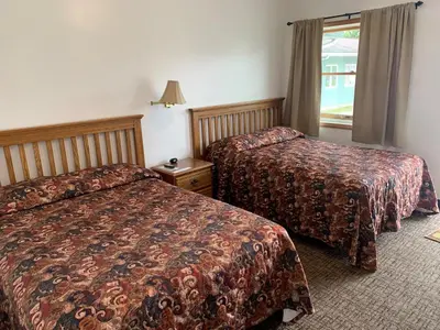 a hotel room with two beds and a window at HAVEN INN in Glendale