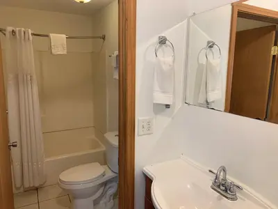 a bathroom with a sink and a toilet and a mirror at HAVEN INN in Glendale