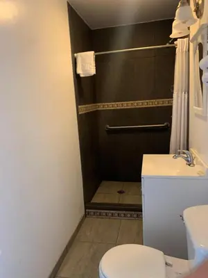 a bathroom with a toilet and a shower at HAVEN INN in Glendale