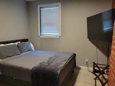 a bedroom with a bed and a window at Spacious Industrial split level with a Balcony in Cincinnati
