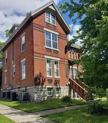 a red brick building with a staircase on it at Spacious Industrial split level with a Balcony in Cincinnati