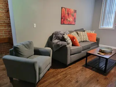 a living room with a couch and a chair at Spacious Industrial split level with a Balcony in Cincinnati