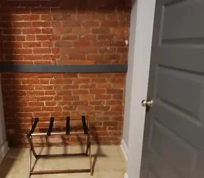 a pair of chairs in front of a brick wall at Fresh Modern Industrial split level in Cincinnati