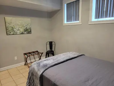 a bedroom with a bed and a chair in it at Fresh Modern Industrial split level in Cincinnati