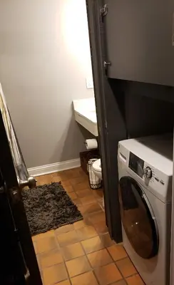 a small laundry room with a washer and dryer at Fresh Modern Industrial split level in Cincinnati