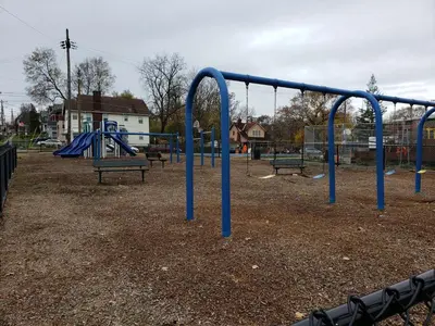 an empty playground with blue bars in a park at Modern style and comfort near UC in Cincinnati