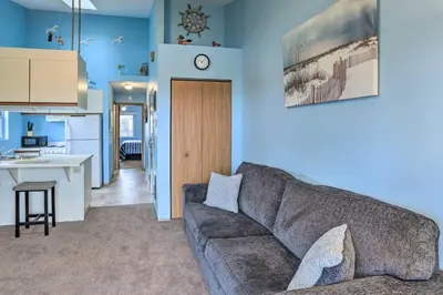 a living room with a couch and a kitchen at Condo with Balcony, Dock and Access to Lake Erie in Sand Beach