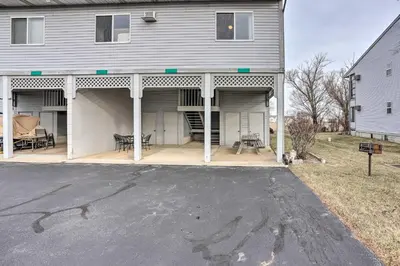 a large house with a garage and a driveway at Condo with Balcony, Dock and Access to Lake Erie in Sand Beach