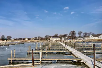 a group of wooden docks in the water at Condo with Balcony, Dock and Access to Lake Erie in Sand Beach