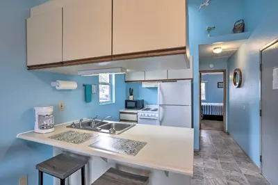 a kitchen with a sink and a refrigerator at Condo with Balcony, Dock and Access to Lake Erie in Sand Beach