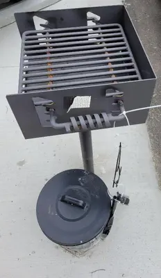 a grill sitting on top of a sidewalk at Modern Rustic split level with balcony in Cincinnati