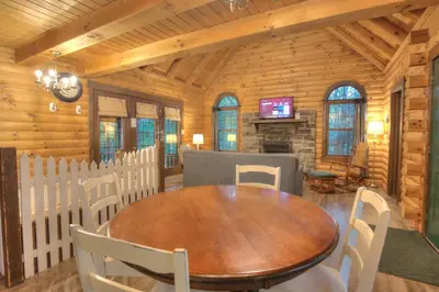 a dining room with a wooden table and chairs at Apple Blossom Cabin by Amish Country Lodging in Millersburg