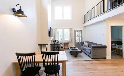 a living room with a table and chairs and a couch at Farmhouse Suites by Amish Country Lodging in Millersburg
