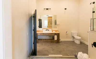 a bathroom with a sink and a toilet at Farmhouse Suites by Amish Country Lodging in Millersburg