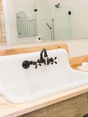 a white sink in a bathroom with a mirror at Farmhouse Suites by Amish Country Lodging in Millersburg