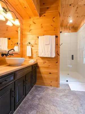 a bathroom with a sink and a shower at Farmhouse Suites by Amish Country Lodging in Millersburg