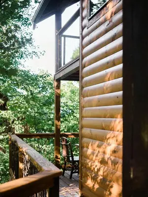 a deck of a cabin with a bench on it at Treehouse #1 by Amish Country Lodging in Millersburg