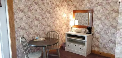 a dining room with a table and a mirror at Victorian Suite by Amish Country Lodging in Millersburg