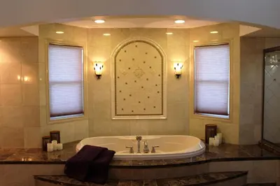 a large bathroom with a tub and two windows at Victorian Suite by Amish Country Lodging in Millersburg