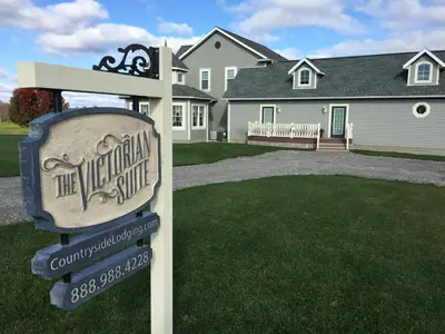a welcome sign in front of a house at Victorian Suite by Amish Country Lodging in Millersburg