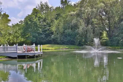 a bridge over a lake with people sitting on it at Waterview Lodge by Amish Country Lodging in Millersburg