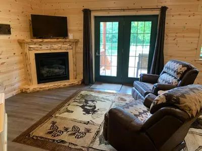 a living room with a couch and a fireplace at Waterview Lodge by Amish Country Lodging in Millersburg