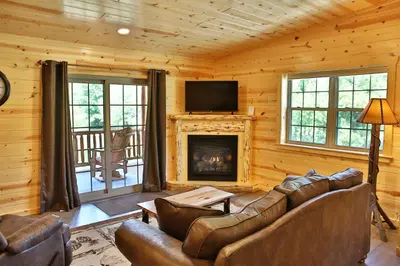a living room with a couch and a fireplace at Waterview Lodge by Amish Country Lodging in Millersburg