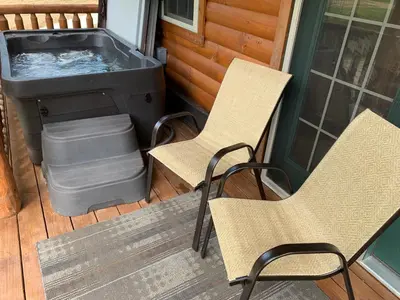 two chairs and a hot tub on a porch at Waterview Lodge by Amish Country Lodging in Millersburg