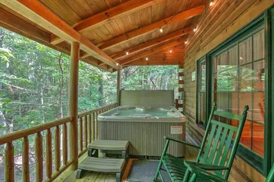 a screened in porch with a grill and a chair at Wild Rose Cabin by Amish Country Lodging in Millersburg