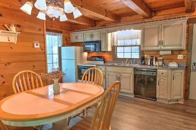 a kitchen with a table and chairs in a room at Wild Rose Cabin by Amish Country Lodging in Millersburg
