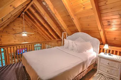 a bedroom with a bed in a wooden cabin at Wild Rose Cabin by Amish Country Lodging in Millersburg