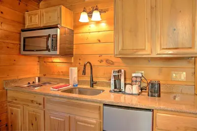 a kitchen with a sink and a microwave at Wild Cherry Treehouse by Amish Country Lodging in Millersburg