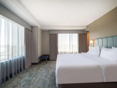 a bedroom with a large bed and a large window at Homewood Suites By Hilton Toledo Downtown in Toledo