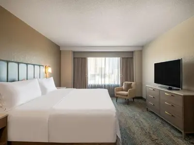 a hotel room with a bed and a television at Homewood Suites By Hilton Toledo Downtown in Toledo
