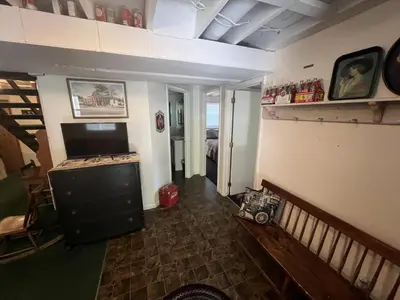 a room with a living room with a television and a room with a room at Rock Stalls Lodge in Logan