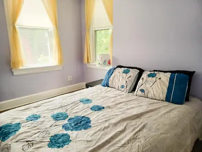 a bedroom with a bed with blue flowers on it at Huge 2 Bedroom House in the Heart of Northside! in Cincinnati