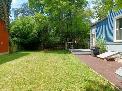 a yard with a fence and a house at Huge 2 Bedroom House in the Heart of Northside! in Cincinnati