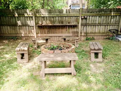 a picnic table and benches in a backyard at Huge 2 Bedroom House in the Heart of Northside! in Cincinnati