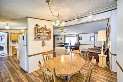 a dining room and living room with a table and chairs at Rustic Family Home and Acreage about 20 Mi Hocking Hills in Lancaster