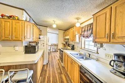 a kitchen with wooden cabinets and a sink at Rustic Family Home and Acreage about 20 Mi Hocking Hills in Lancaster