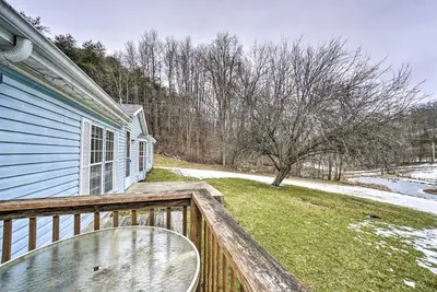 a balcony of a blue house with snow on the ground at Rustic Family Home and Acreage about 20 Mi Hocking Hills in Lancaster