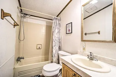a bathroom with a sink and a toilet and a tub at Rustic Family Home and Acreage about 20 Mi Hocking Hills in Lancaster